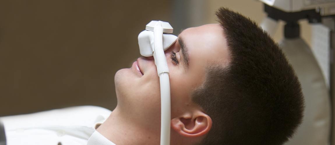 Patient receiving oral surgery with sedation dentistry