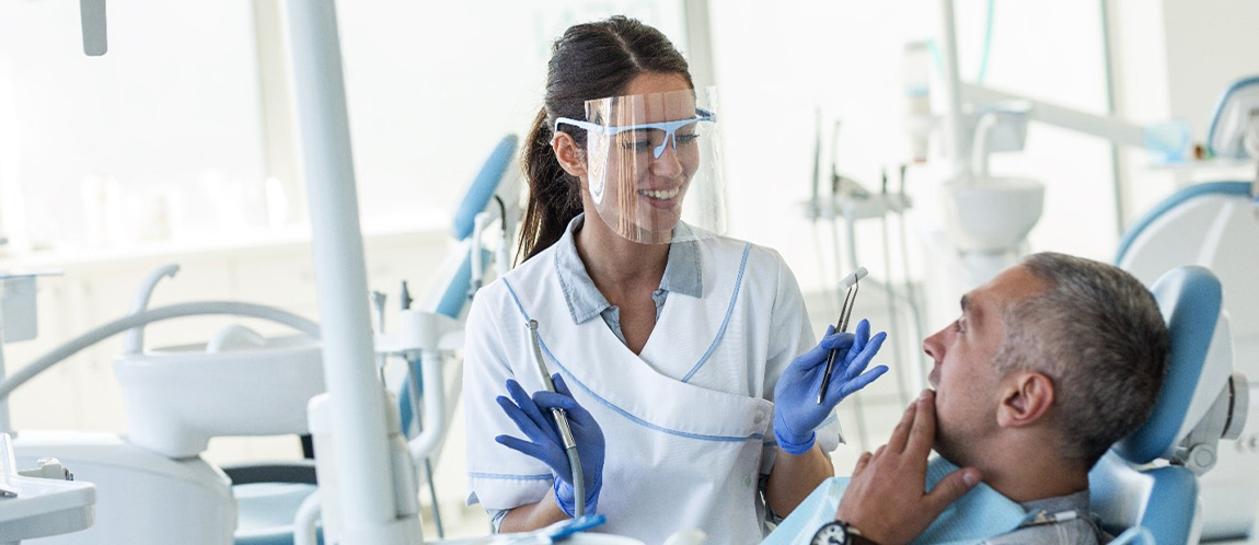 Dentist explaining treatment to older patient