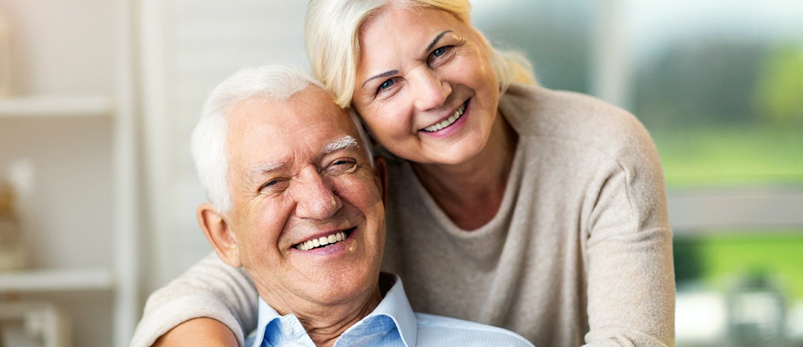 Older couple smiling at home