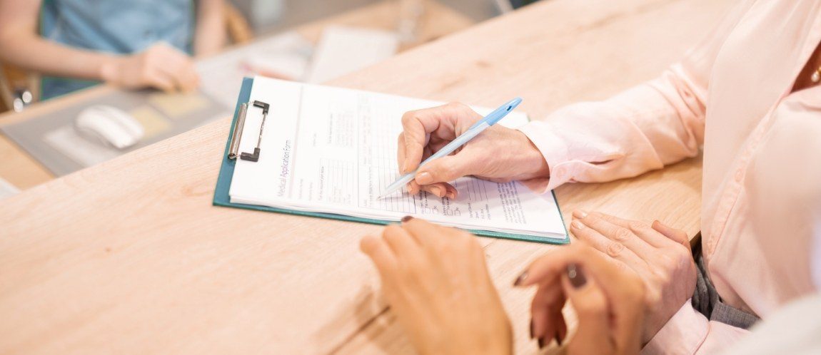 Patient filling out dental insurance forms