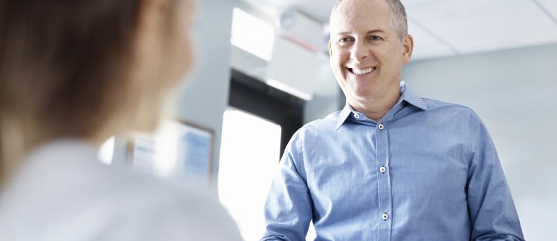 Smiling man at reception desk