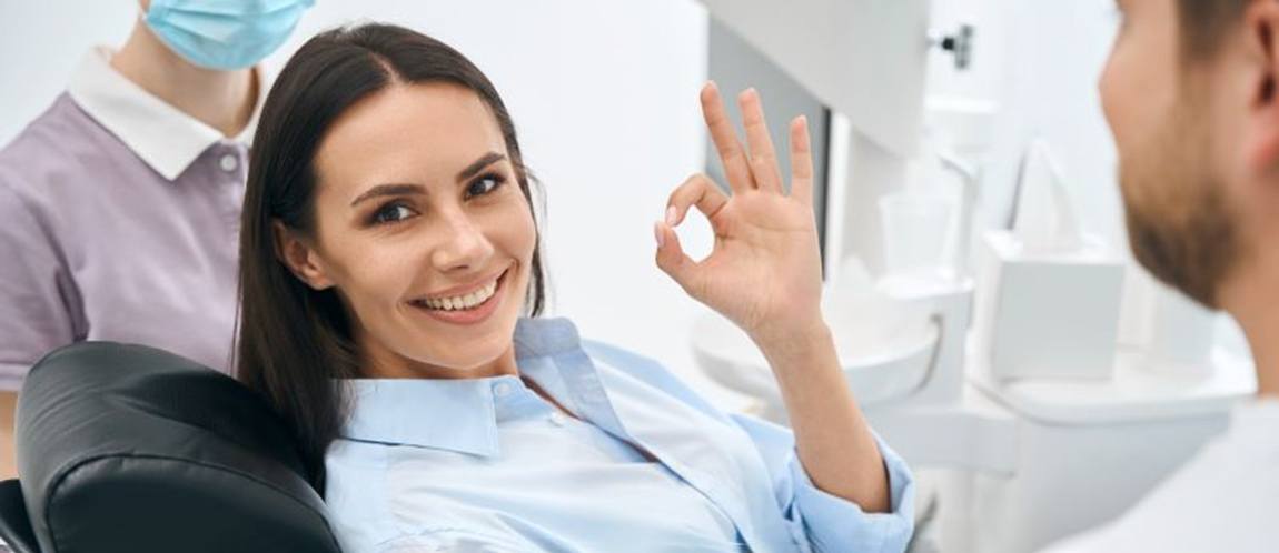 Dental patient making okay sign with hand