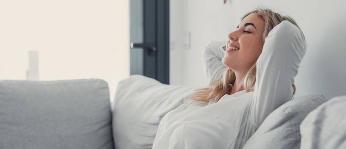 Woman relaxing at home on sofa