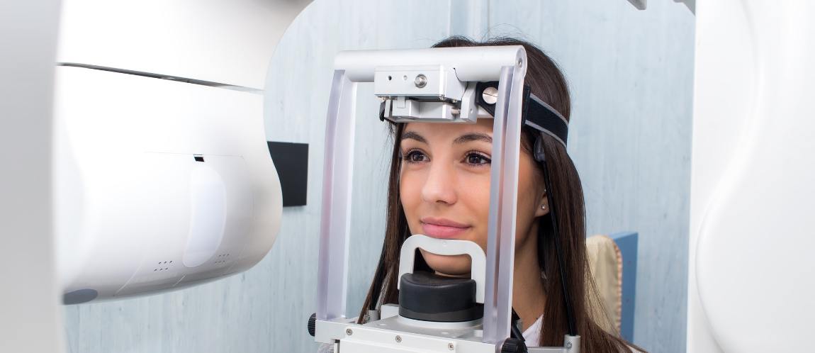 Woman receiving cone beam scan of her mouth and jaw