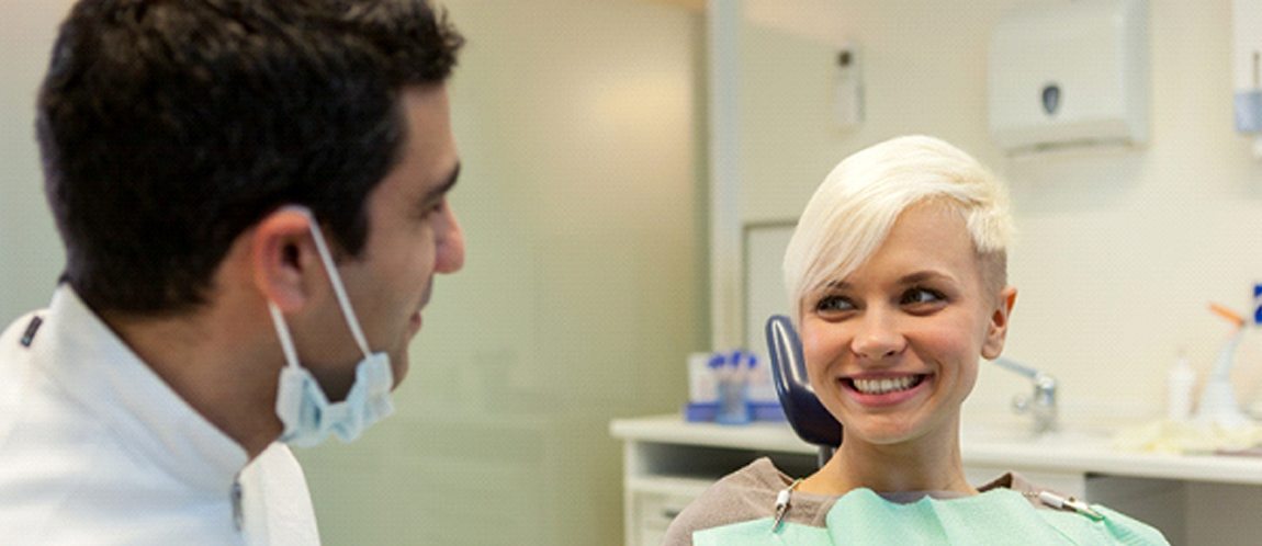 Dentist speaking with a patient