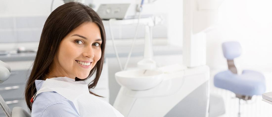 Smiling woman sitting in chair at dental office