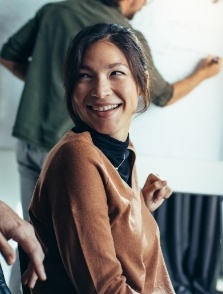 Woman smiling in brown jacket