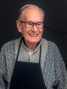 Man smiling in gray sweater