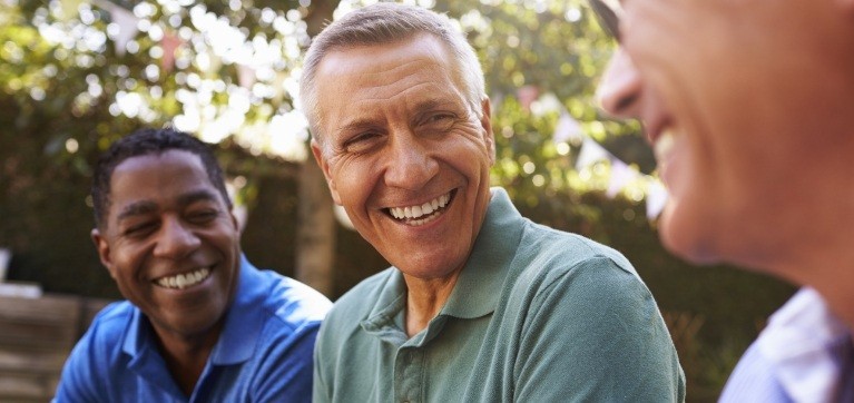 Man sharing healthy smile after tooth repalcement with dental implants