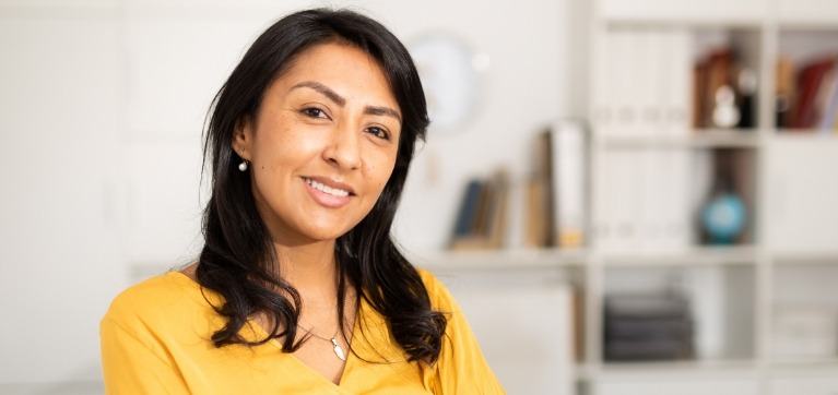 Woman smiling in yellow blouse