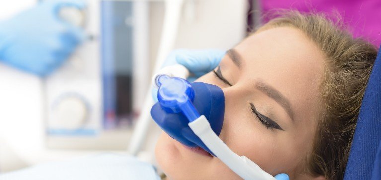 Woman with nitrous oxide mask on her nose