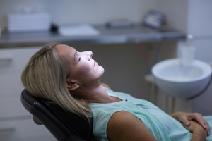 Oral surgery patient sitting back and relaxing